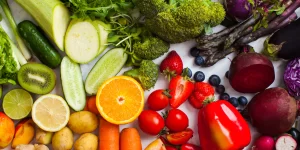 Selection of colourful fruit and vegetables on a white background represented the rainbow good for diet